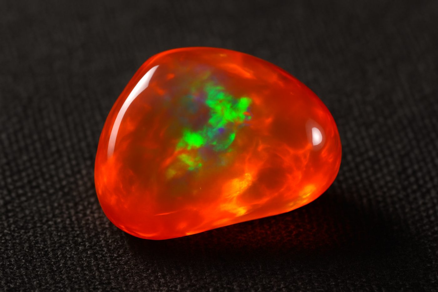 a close-up view of a fire opal displaying its unique colors and transparency
