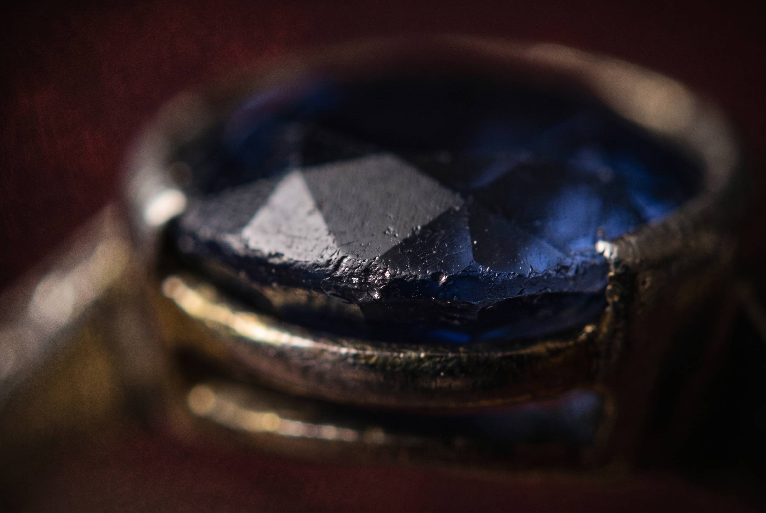 Macro view of a worn ring girdle showing rounded facet edges and fine chipping