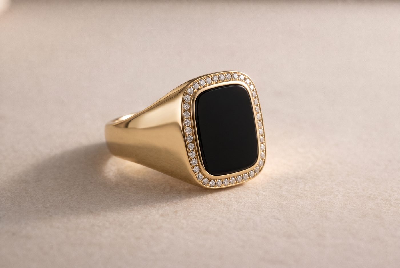 Yellow gold band with inlaid black onyx tablet and fine diamond pavé border